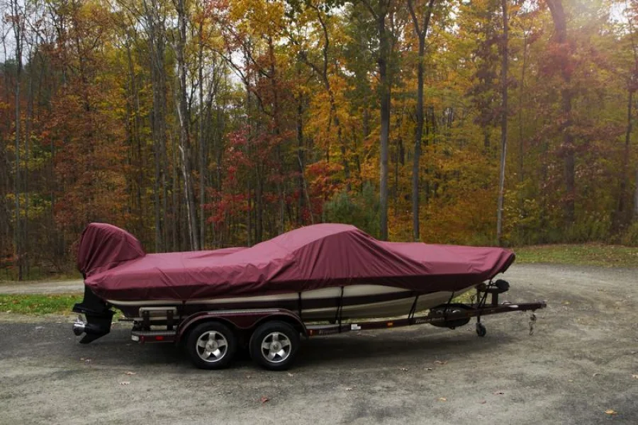 Burgundy semi-custom boat cover fitted to a trailered fish-and-ski boat