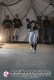 Baseball player completing a swing inside an indoor pitching dome