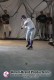 Baseball player preparing to hit a ball inside a netted pitching dome