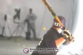 Rear view of a batter holding a bat inside a pitching dome