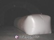 End view of a white inflatable pitching dome inside a dark Sport Dome