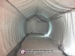 Empty netted batting lane inside a white inflatable pitching dome