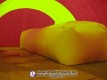 White inflatable pitching dome inside a red and yellow Sport Dome