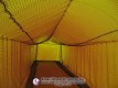 Centered view down the netted lane inside the pitching dome
