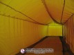 Angled view down the netted lane inside the pitching dome