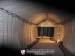 Lighting stand beside the dark impact screen in the pitching dome