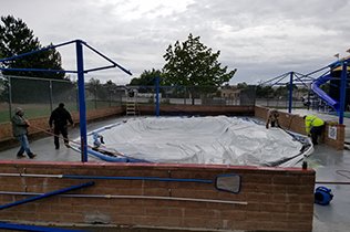 Construction dome spread over pool