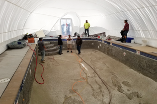 Construction Dome - Inside view of workers prepping pool area to lay plaster.