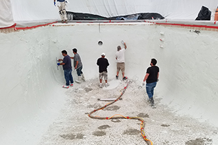 Construction Dome - Inside view of workers laying plaster