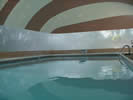 Interior of a tan and white striped pool dome.