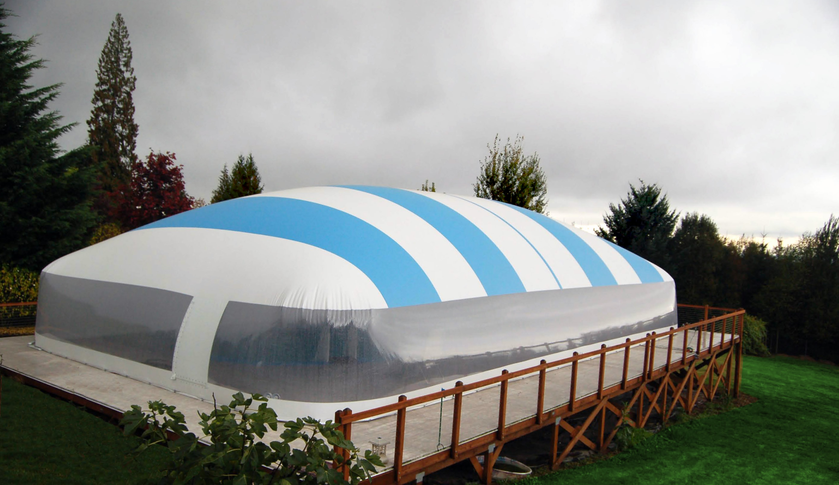 Blue and white Ameri-Dome installed over an elevated residential pool deck