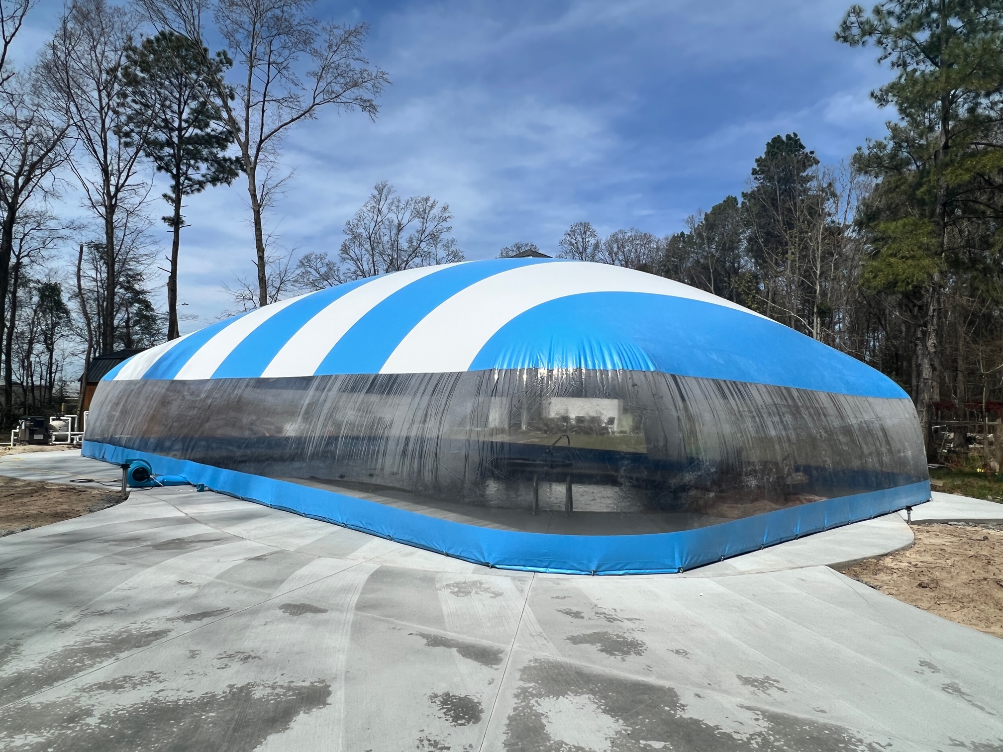 Blue-and-white Ameri-Dome installed over a residential swimming pool