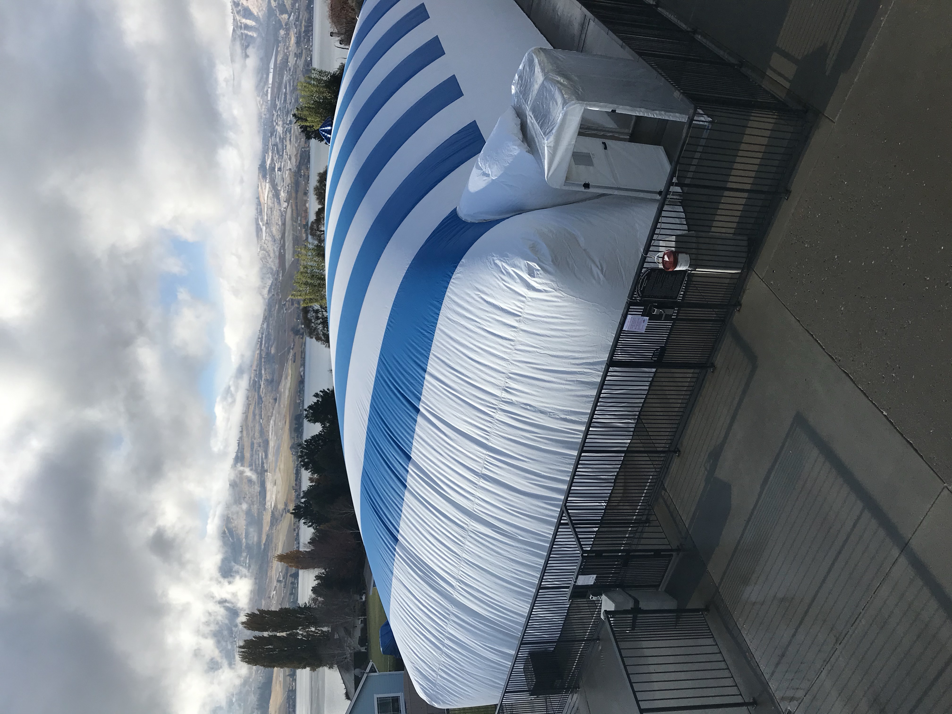 Blue and white Ameri-Dome installed around a pool deck