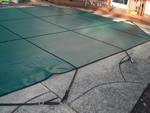 Side profile of a green solid vinyl pool cover.