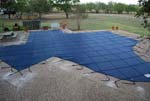 Large blue swimming pool cover in the shape of Texas.